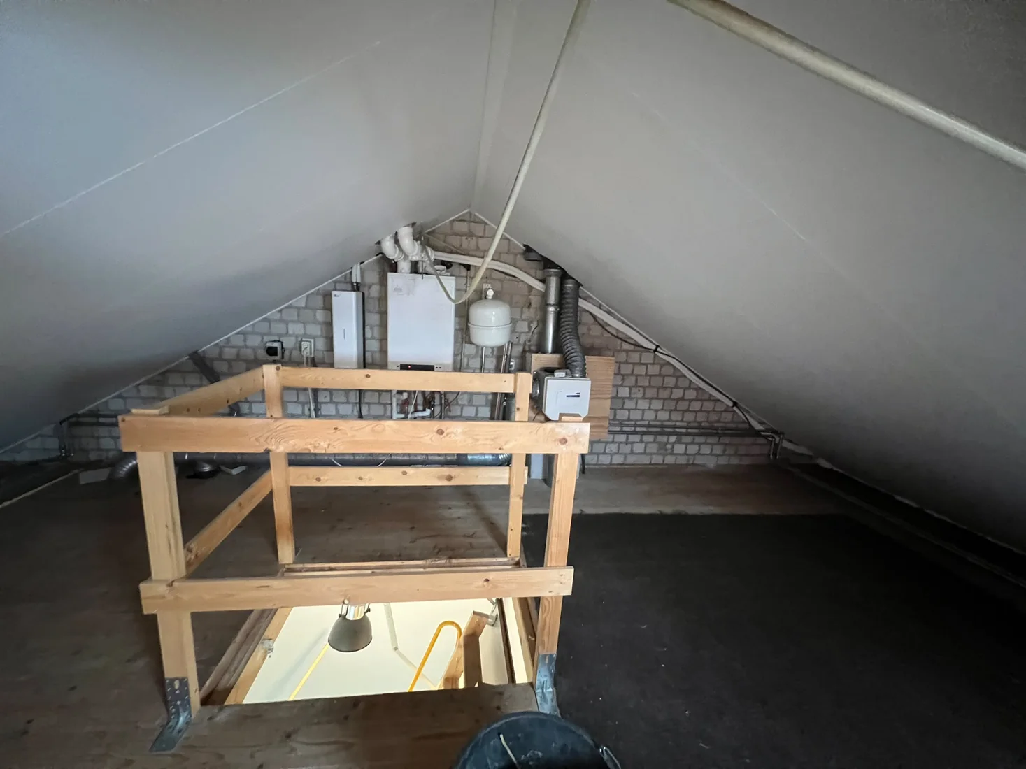 Existing attic with a timber floor, balustrade and building services